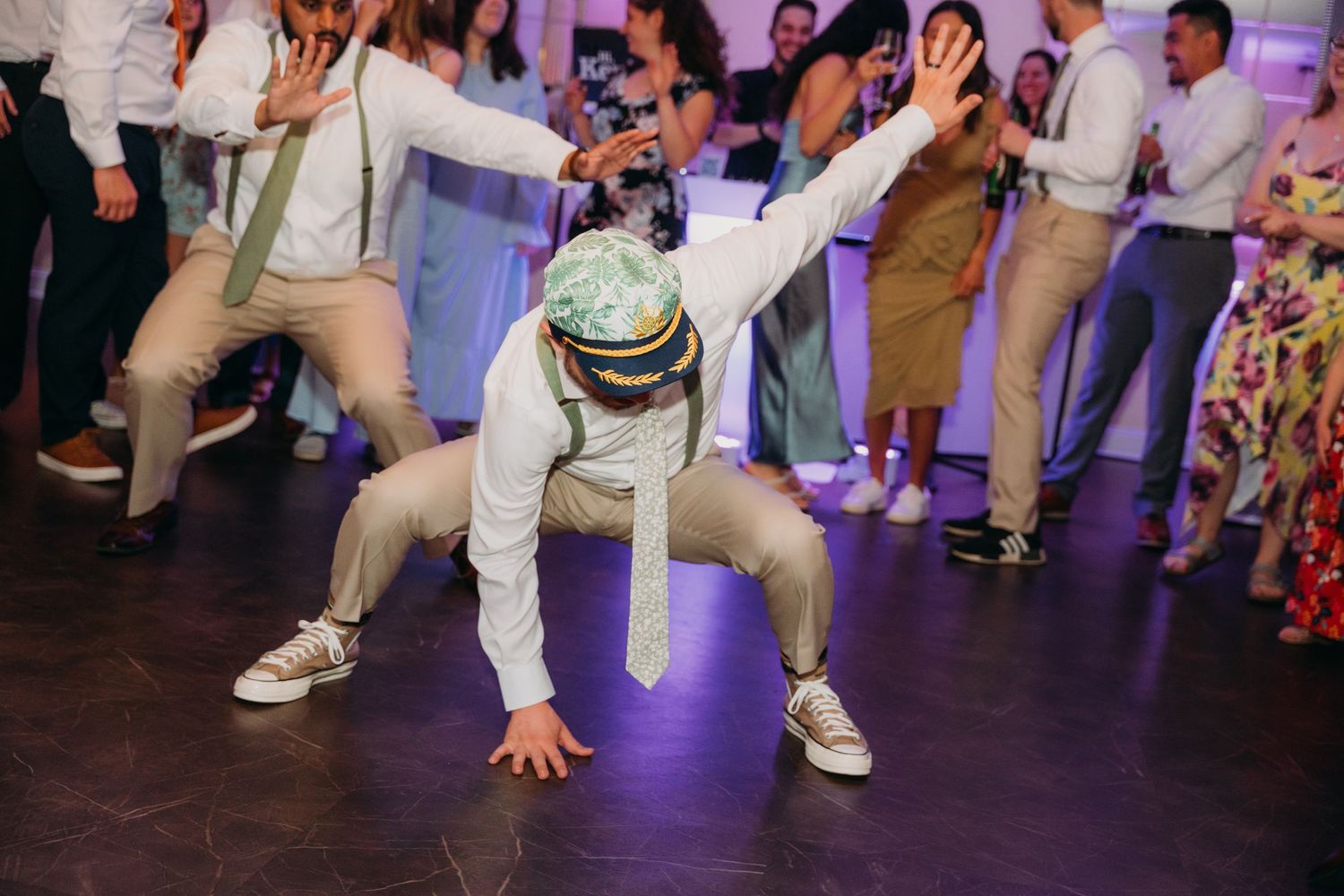 Low-angle shot of dancers' feet and legs during an energetic wedding reception.