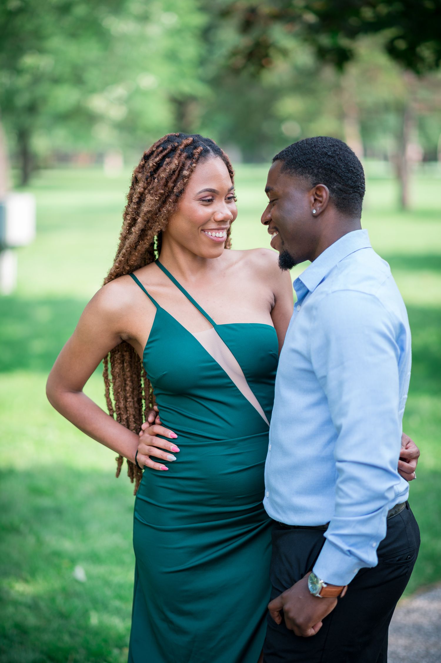 A couple in casual attire sharing intimate moments during an outdoor photo session.