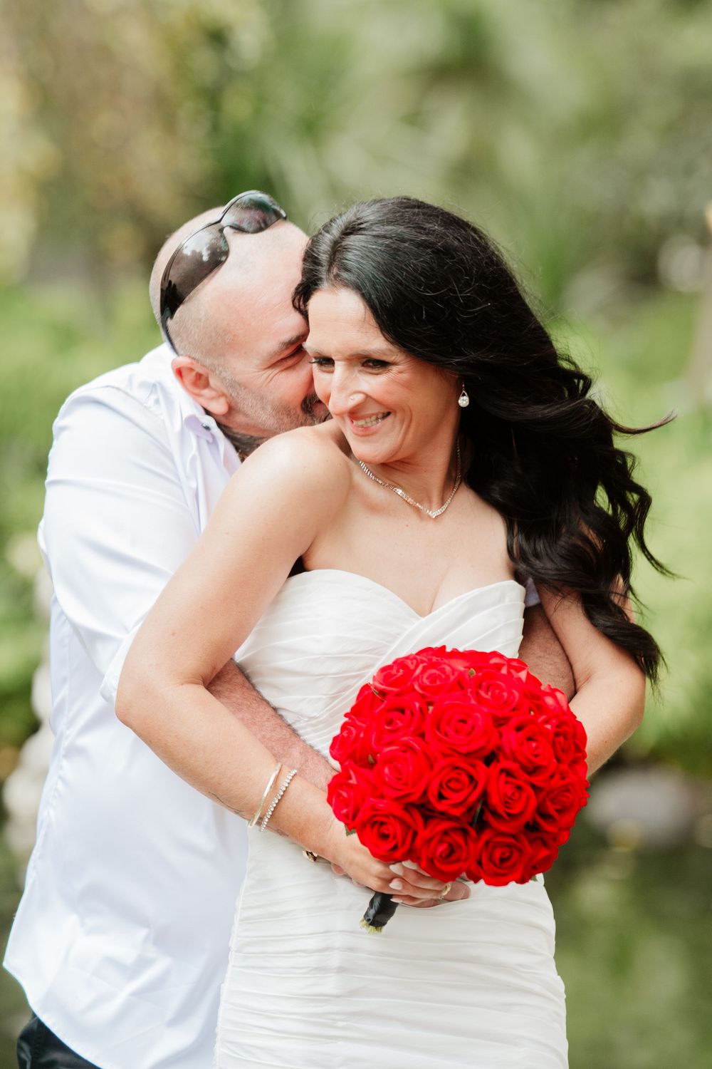 Candid wedding photography sequence showing tender moments between newlyweds with red rose bouquet.