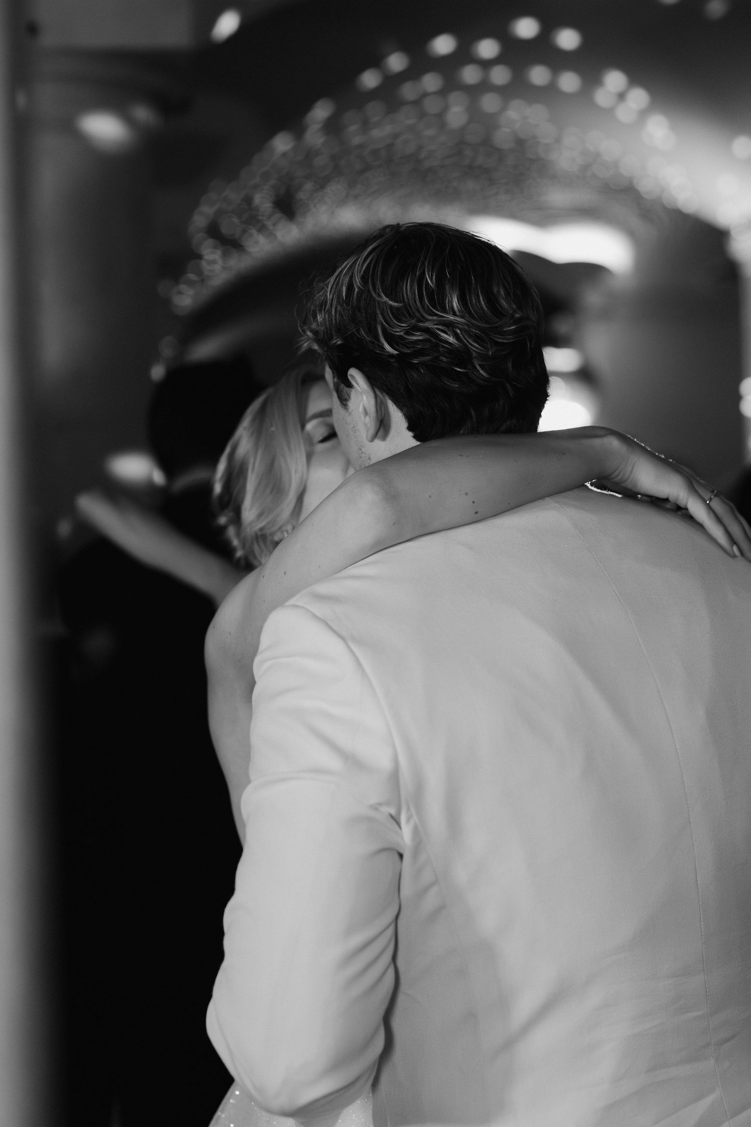 bride and groom kissing during the first dance in the vaults at the ashmolean museum in Oxford