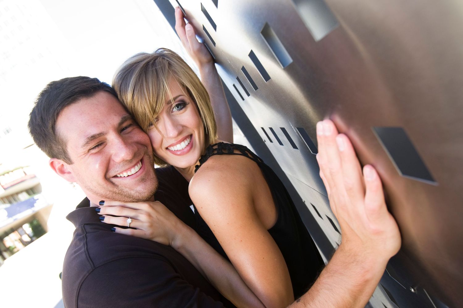 Playful candid moments captured in casual engagement photo session.