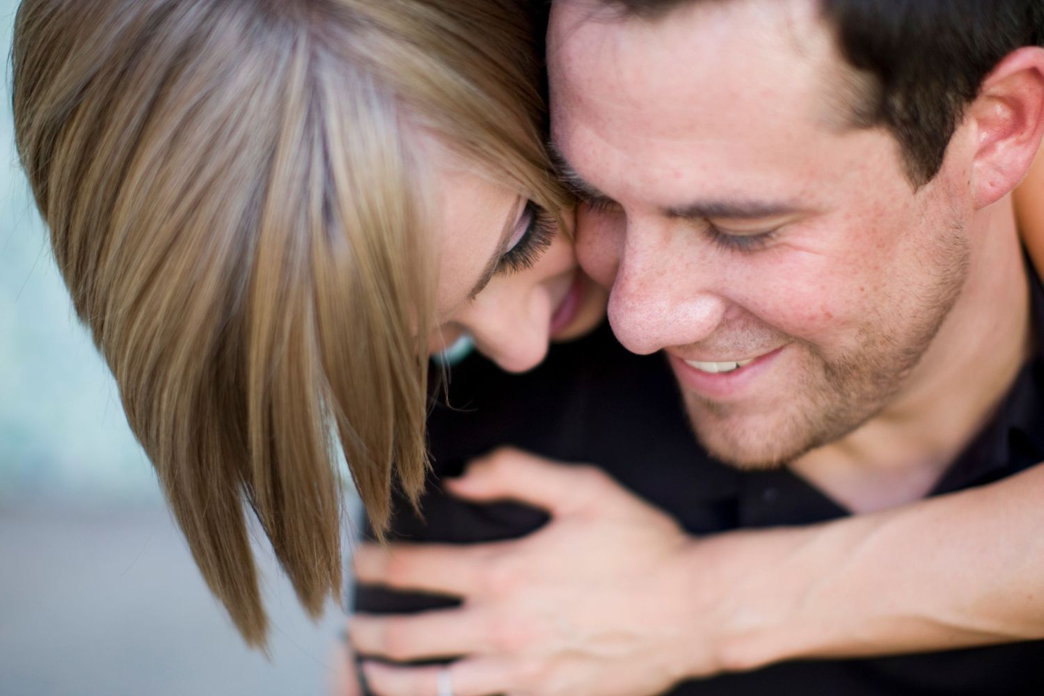 Sweet candid moments shared between couple during engagement session.
