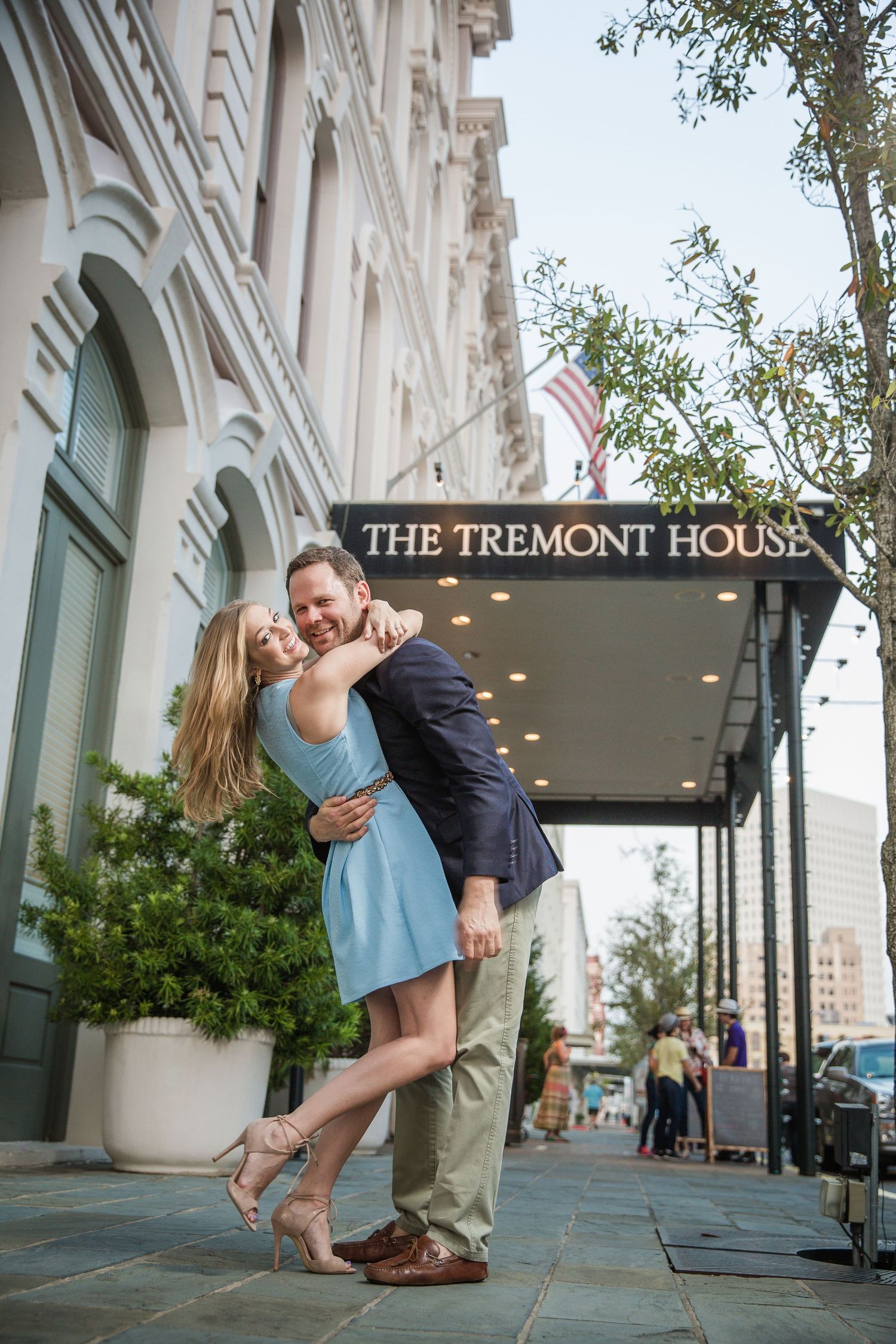 Romantic dip pose in front of The Tremont House with classic architecture.