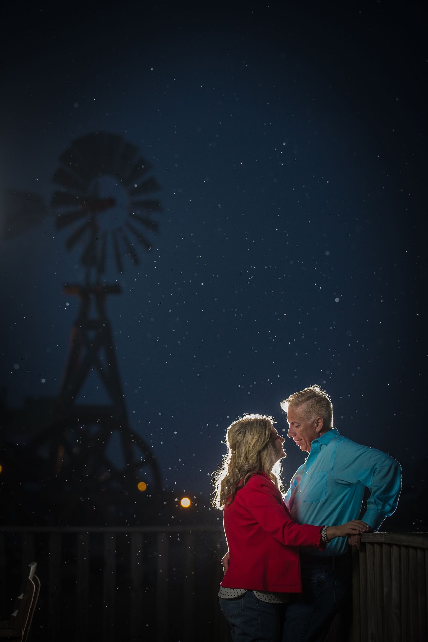 Nighttime stargazing scene with silhouettes against a dark sky.