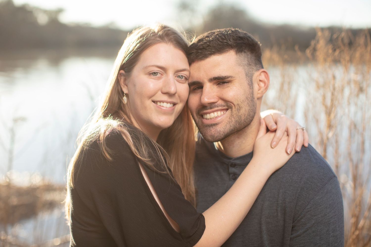 Intimate outdoor photo session in a natural setting with golden sunlight.