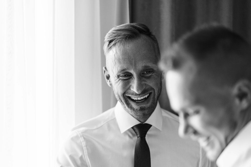 Two people share a joyful moment while wearing formal attire.