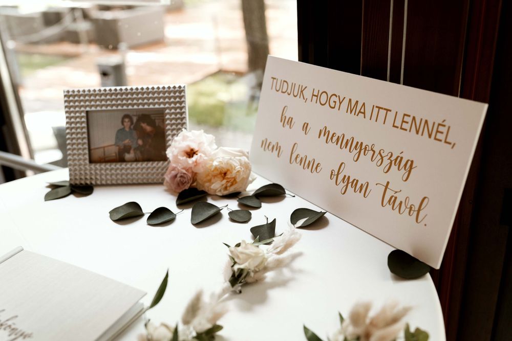 Wedding guest book table with calligraphy sign, flowers and decorative elements.