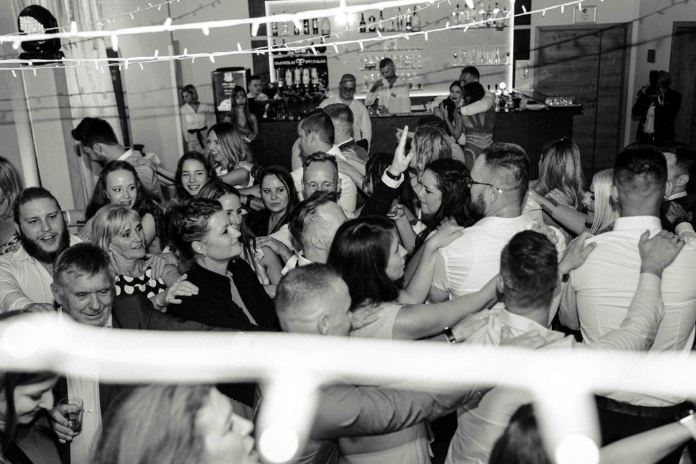 Black and white photo of a crowded dance floor with people dancing at a party.