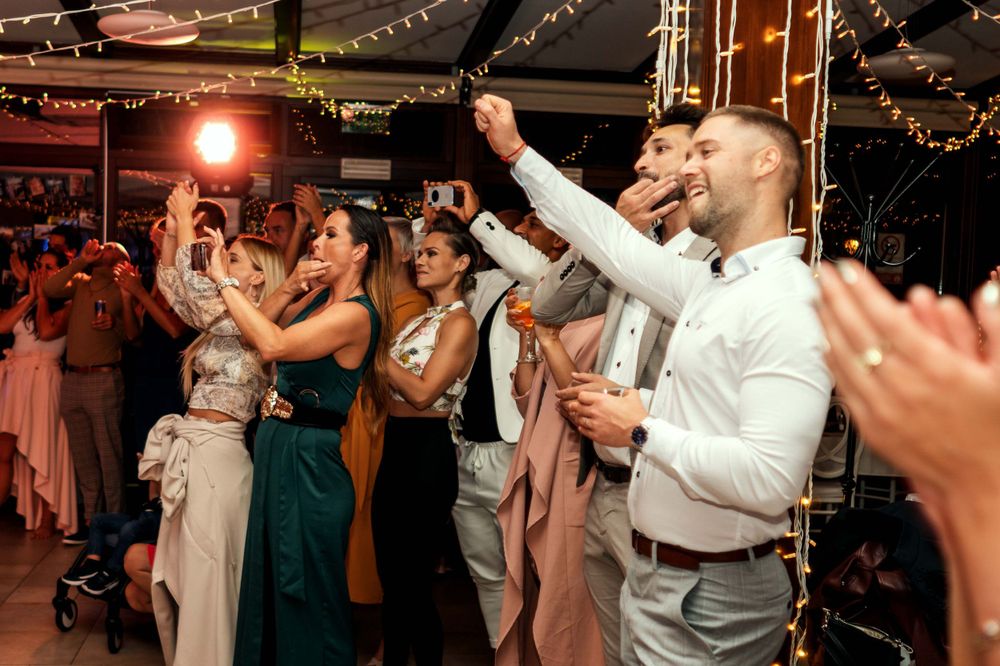 Black and white photo of dancers moving on the dance floor at a reception.