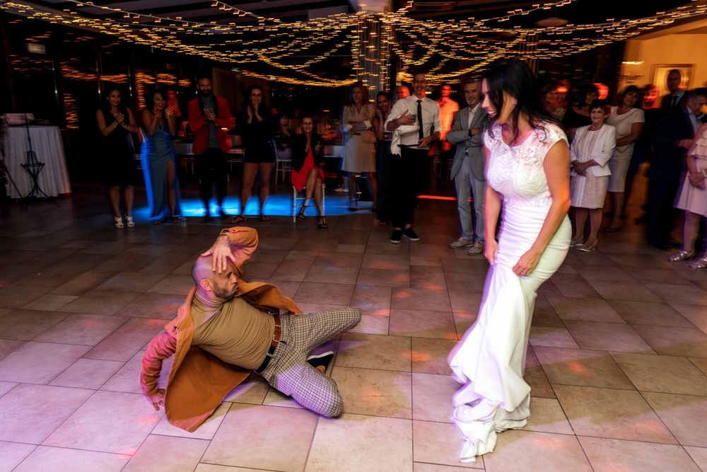 Candid black and white shot of people in a hallway during an event.