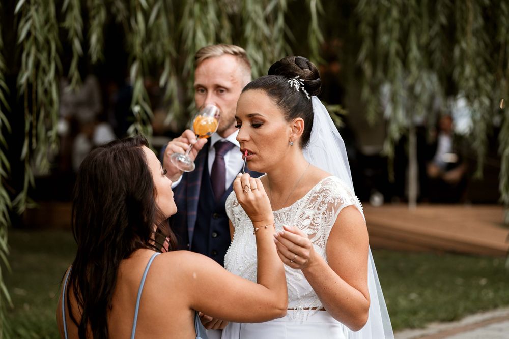 Wedding celebration at an outdoor venue with guests enjoying drinks and snacks.