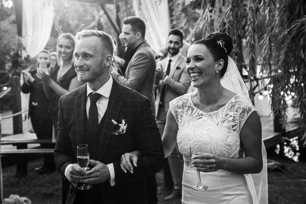 A black and white photo of a celebration at an outdoor wedding reception.