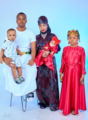 Family portrait featuring traditional and modern attire with white and red color coordination.