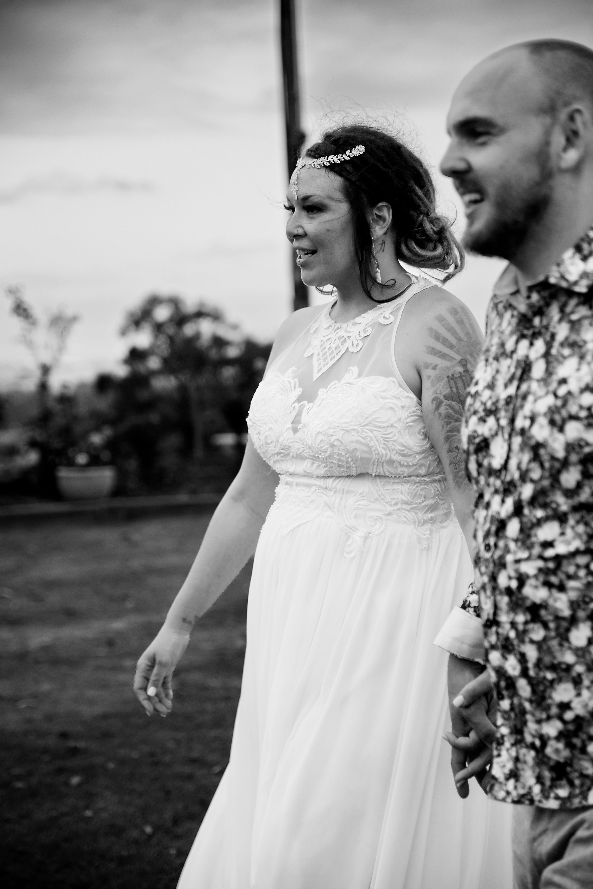 Black and white wedding photo showing a couple outdoors with the bride wearing a flowy white dress and delicate headpiece. Valley View Manor
