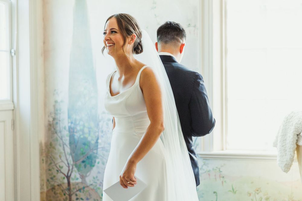 Joyful wedding day scene in a bright room with elegant decor and natural lighting.