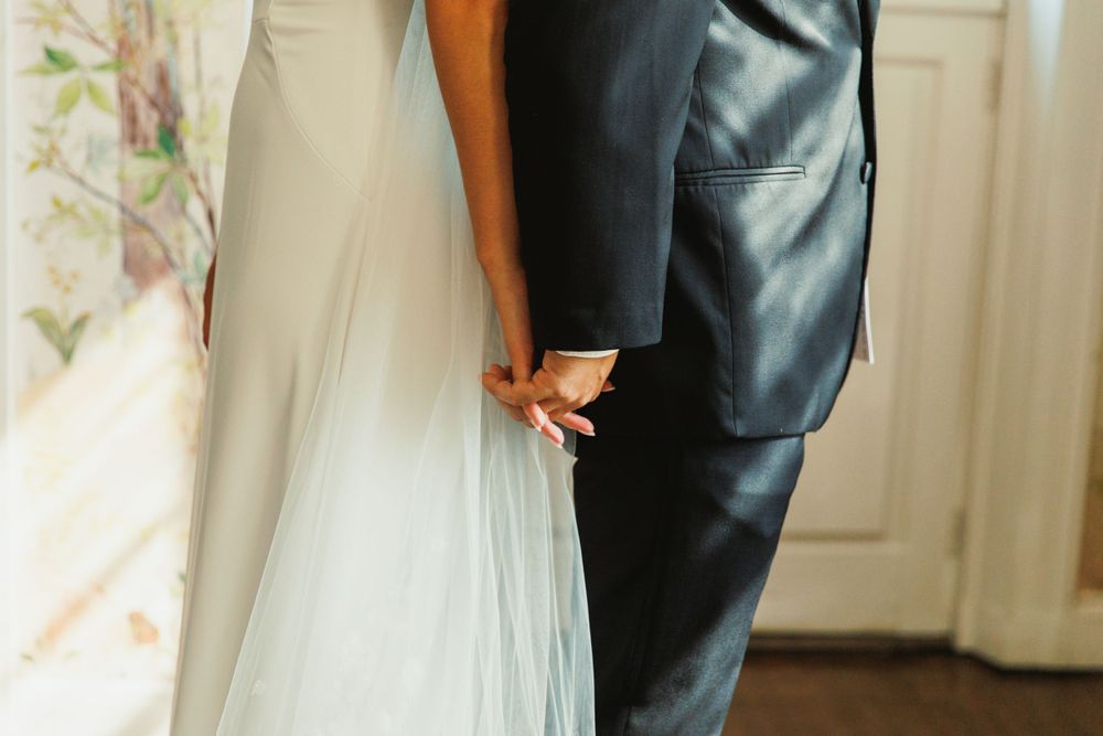 Wedding couple sharing a special moment in an elegantly decorated room with natural light.
