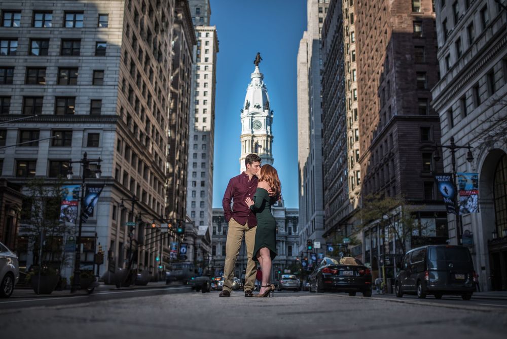 Romantic silhouette against Philadelphia City Hall towers and blue sky on Broad Street.