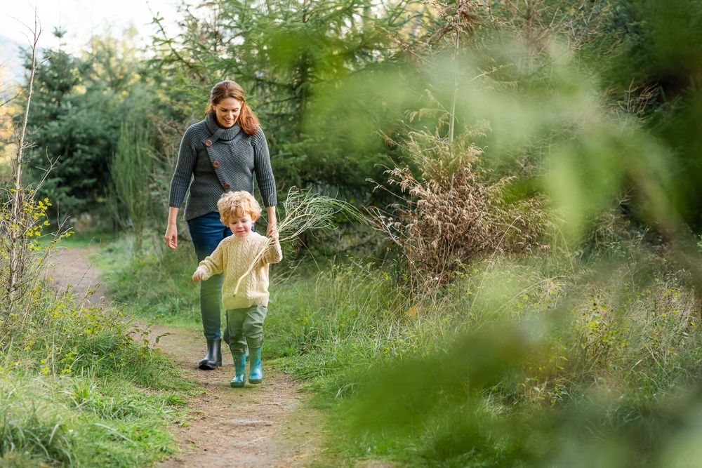 Mother follows son through a forest in North Bend.