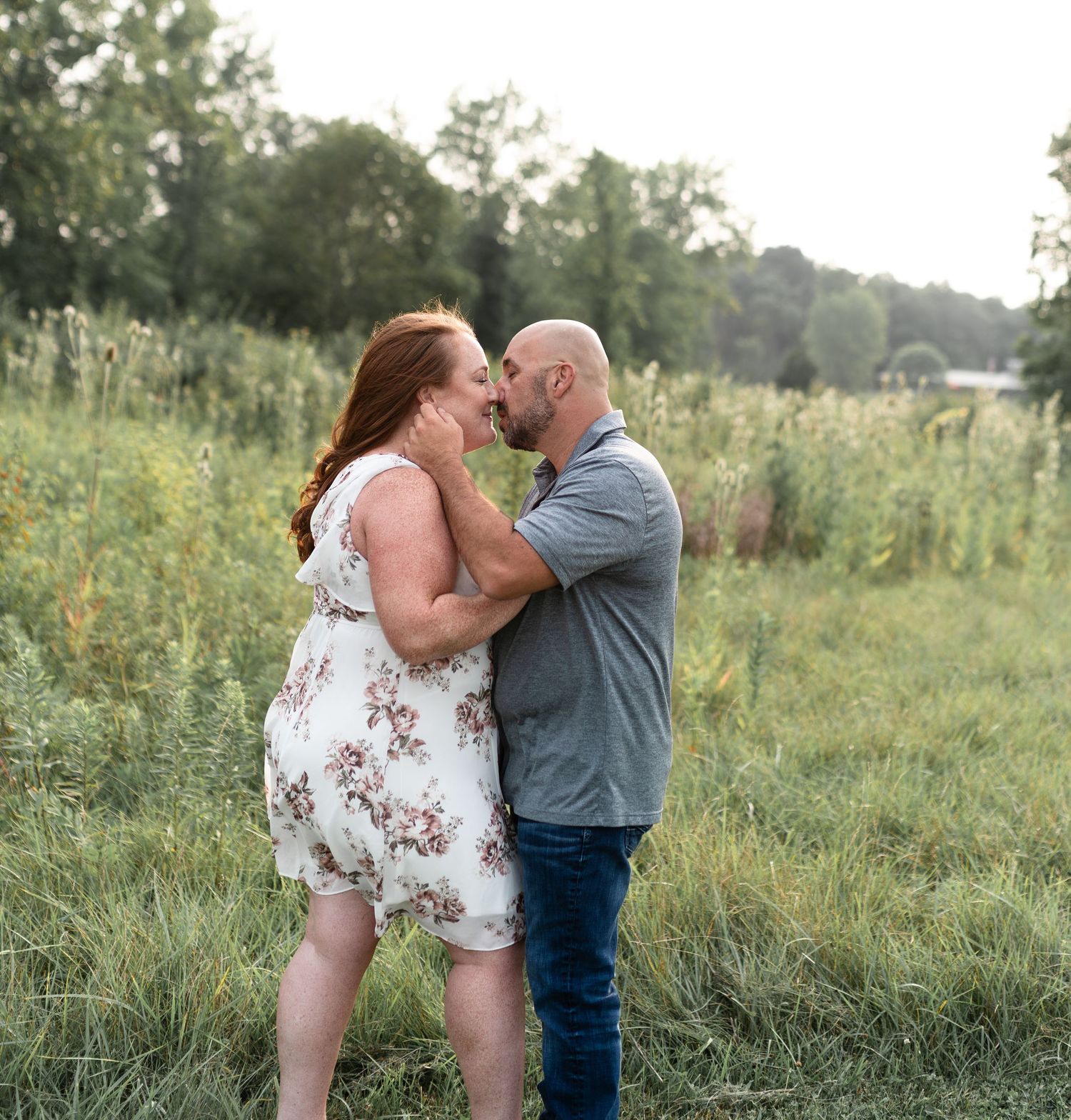 Couple engaged and kissing in a field of wildflowers. Alum Creek Beach State Park, Ohio
