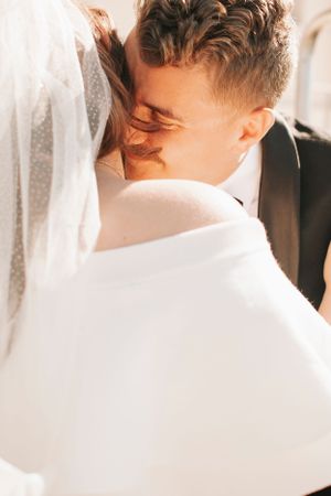 Intimate wedding photo showing tender moment between newlyweds.