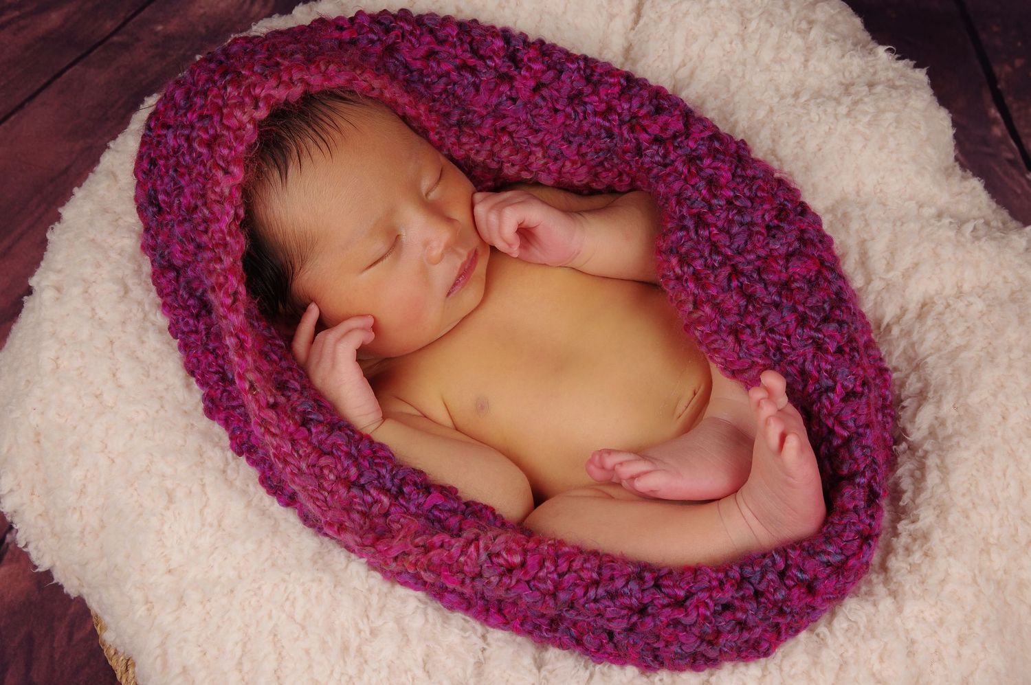 newborn photography of baby girl wrapped in a cocoon