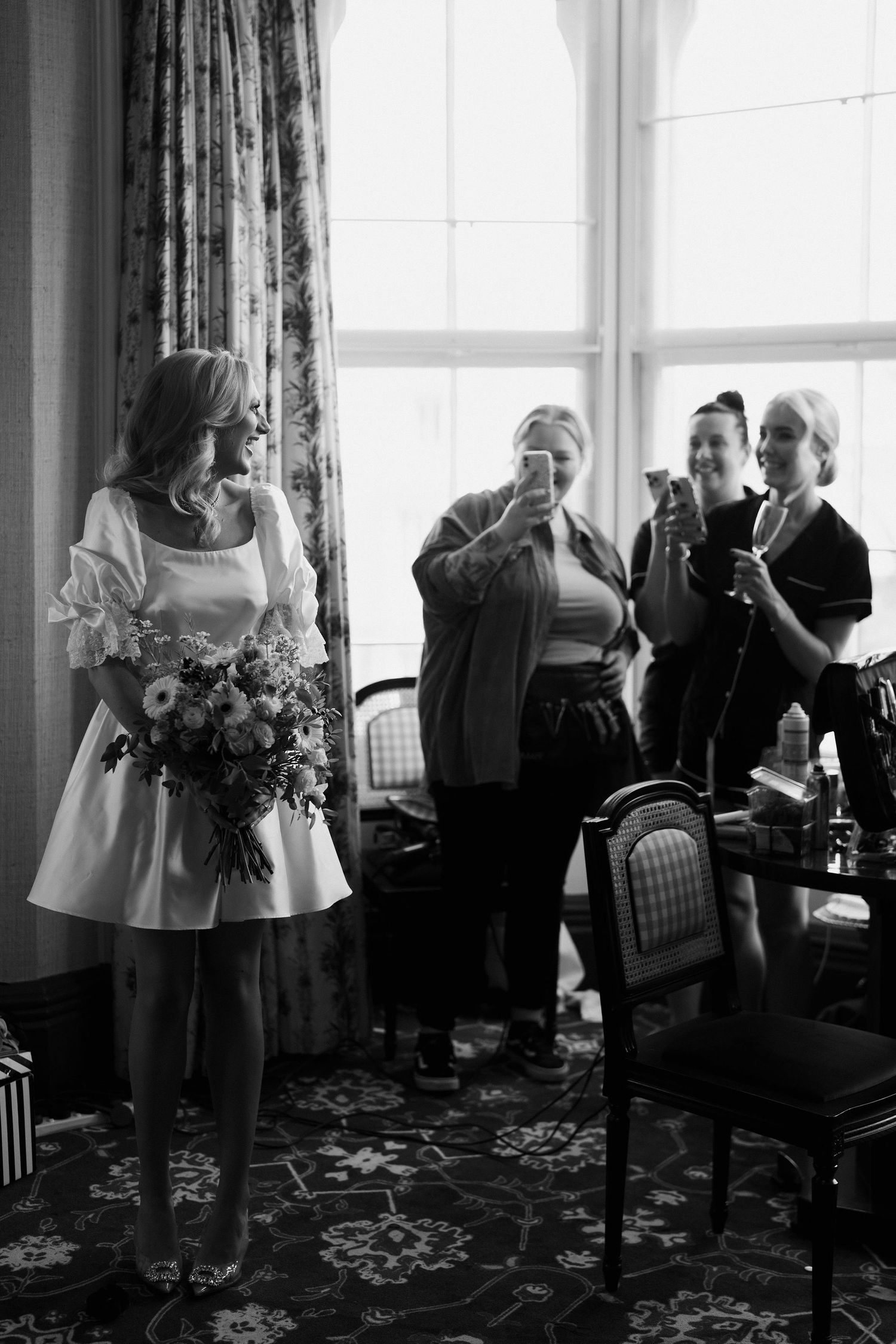 hair stylist taking photos of laughing bride at the Randolph hotel in oxford