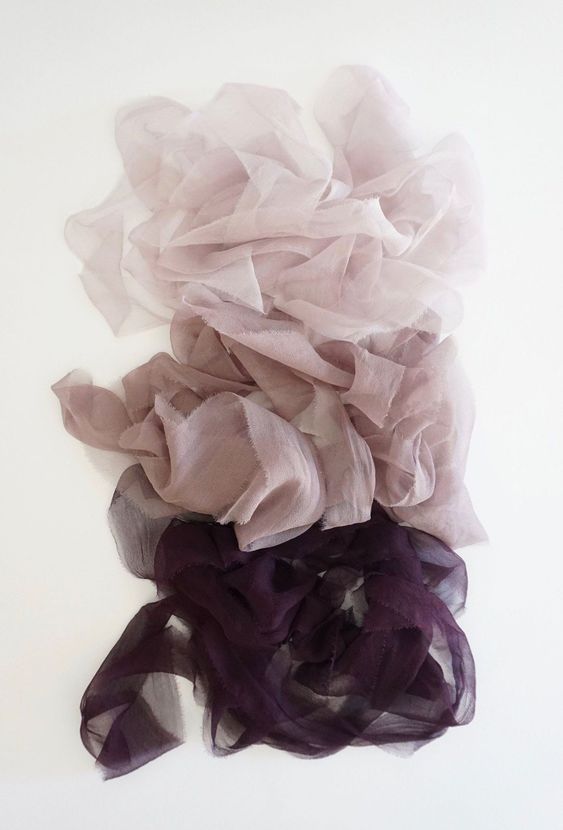 Ruffled fabric in dusty rose and deep purple creating a romantic gradient effect.