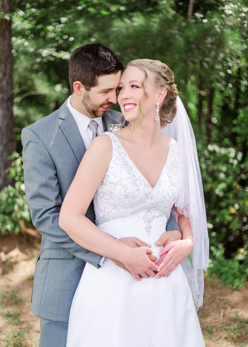 Intimate wedding couple portraits in a wooded setting with natural light filtering through trees, by best San Antonio Photographer.