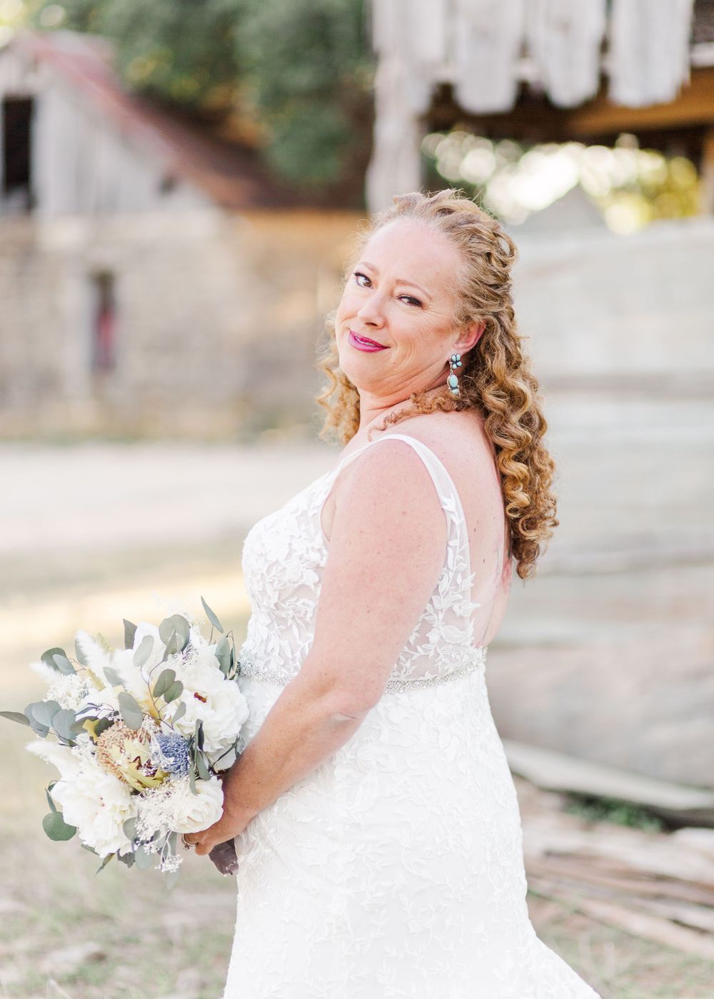 Candid bridal portraits showing joyful moments in a white lace gown with cascading bouquet.