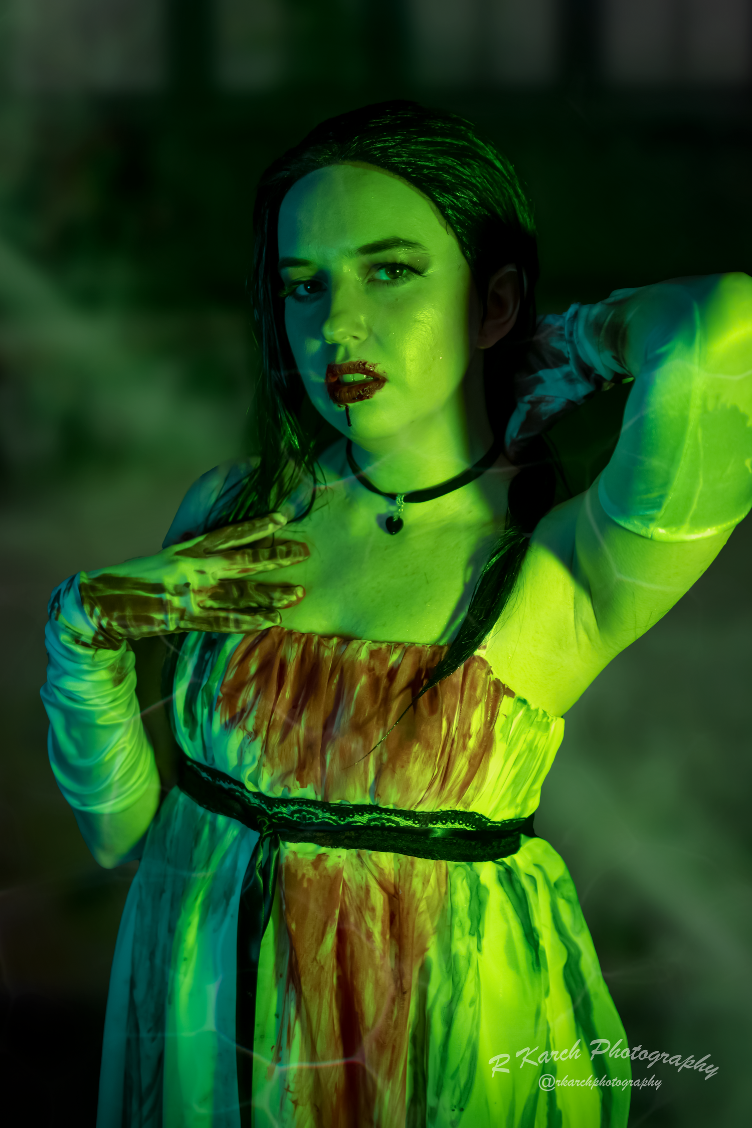 Ethereal gothic portrait with glowing green lighting and dramatic vintage-style dress.