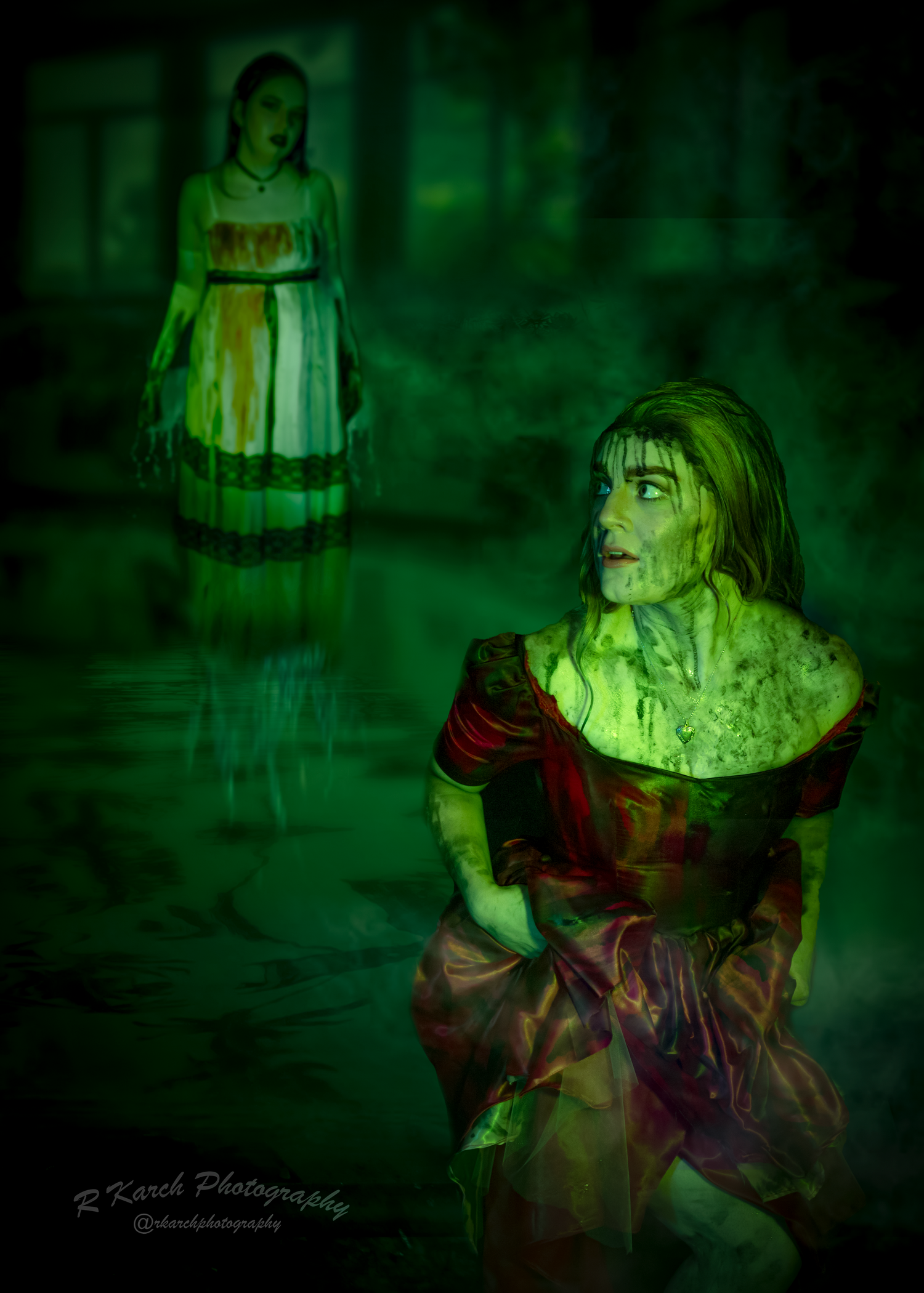 Haunting scene with two figures in period dresses illuminated by eerie green lighting.