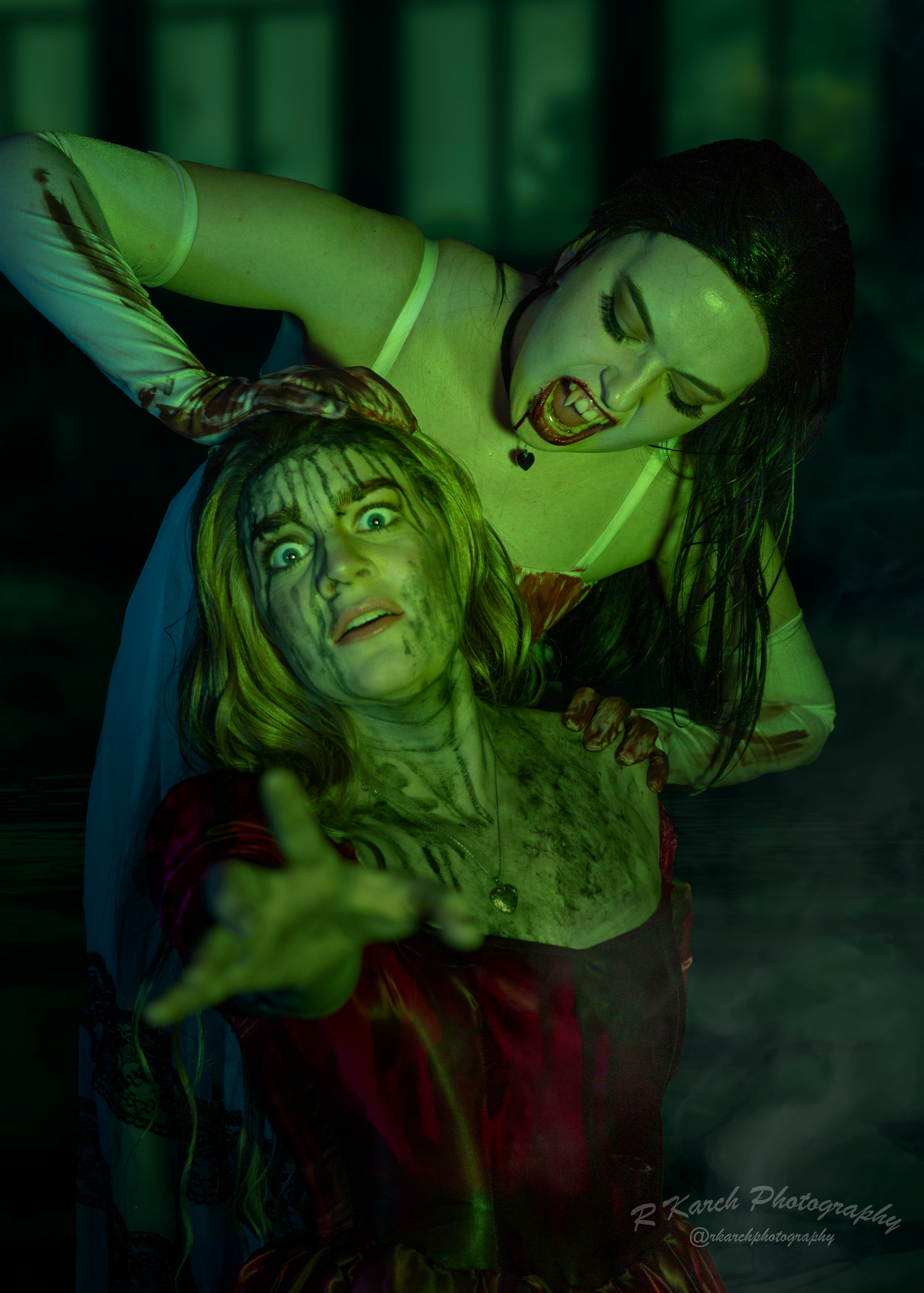 Gothic horror scene with two figures in dramatic poses under green lighting effects.