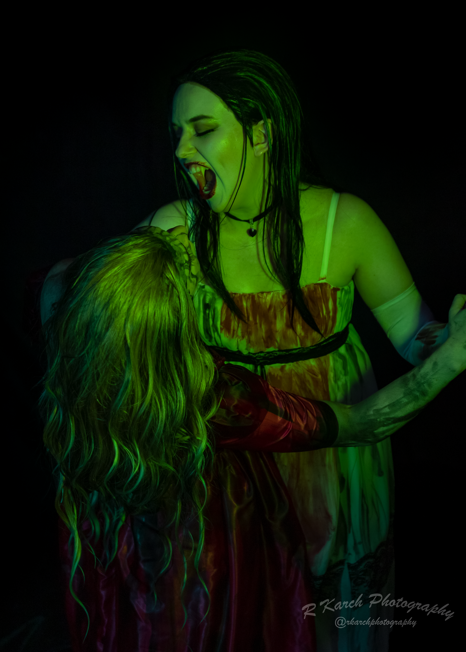 Horror themed portrait with dramatic green lighting and gothic costume elements.