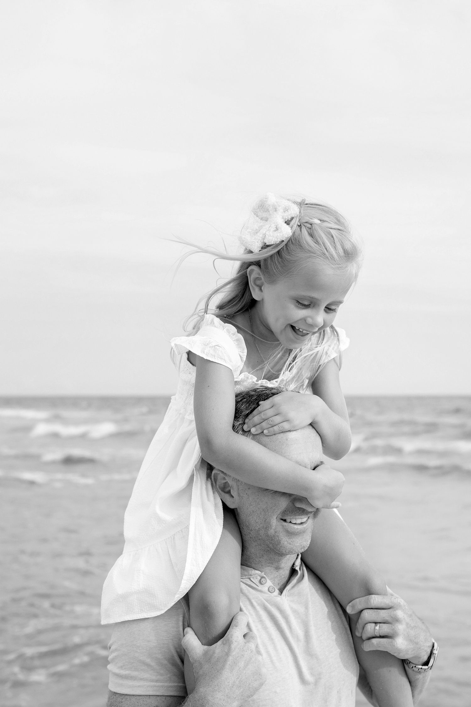 Little girl on her dad shoulder laughing in Rosemary beach Florida