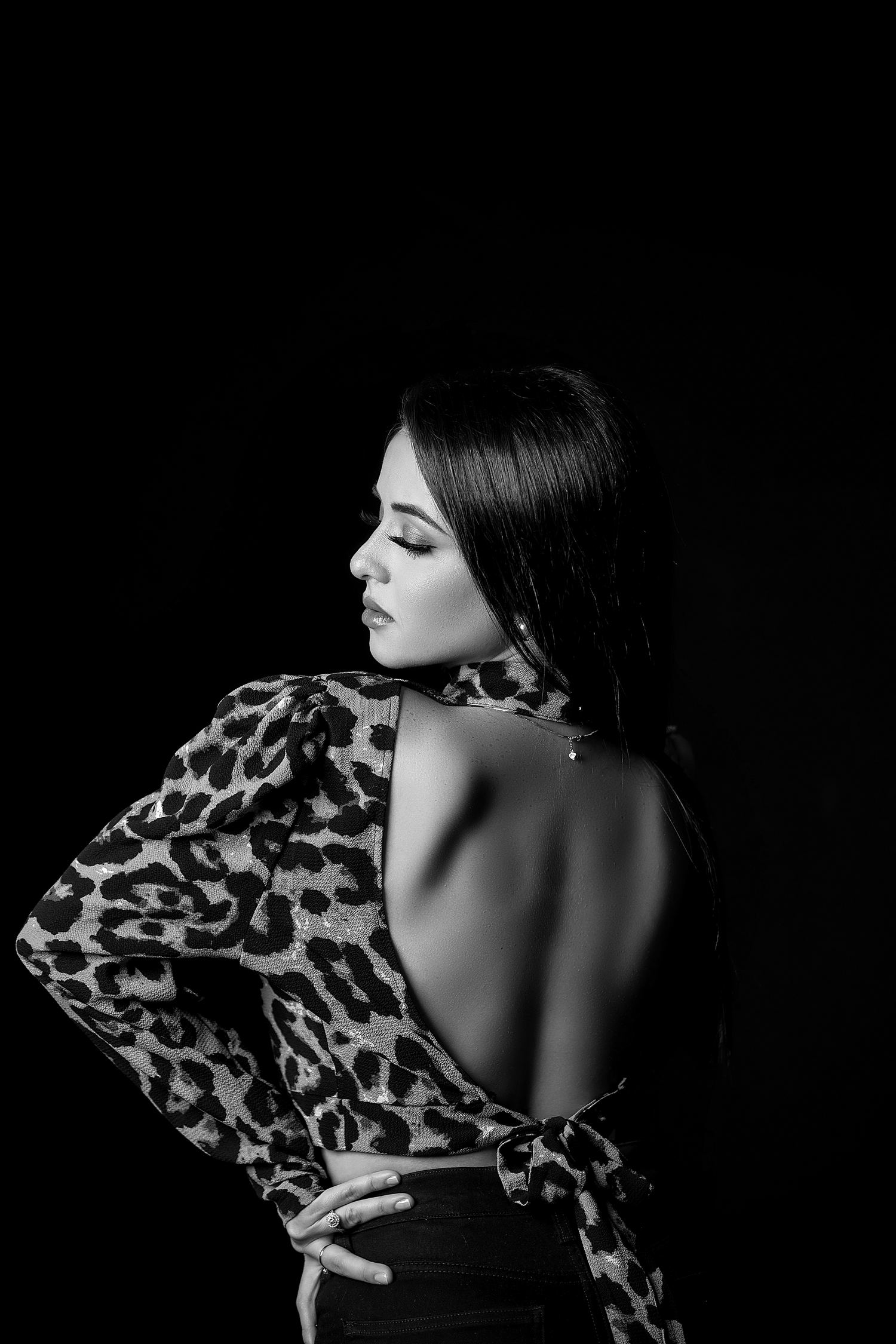 Artistic black and white photos featuring leopard print garment with dramatic side poses.