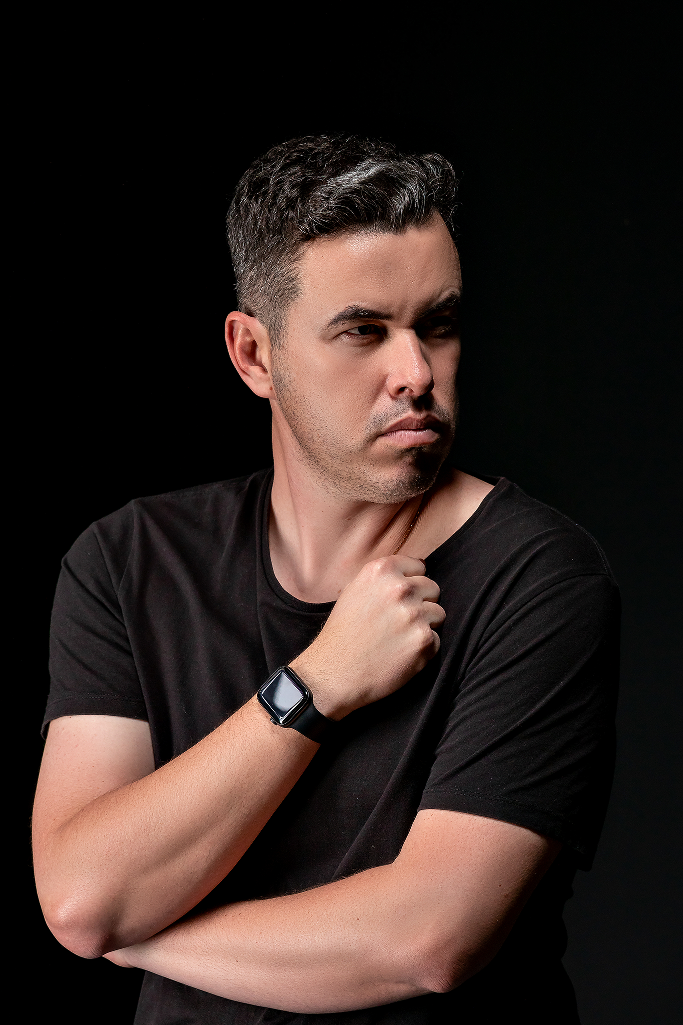 Dramatic black and white portrait series featuring contemplative poses against dark background.