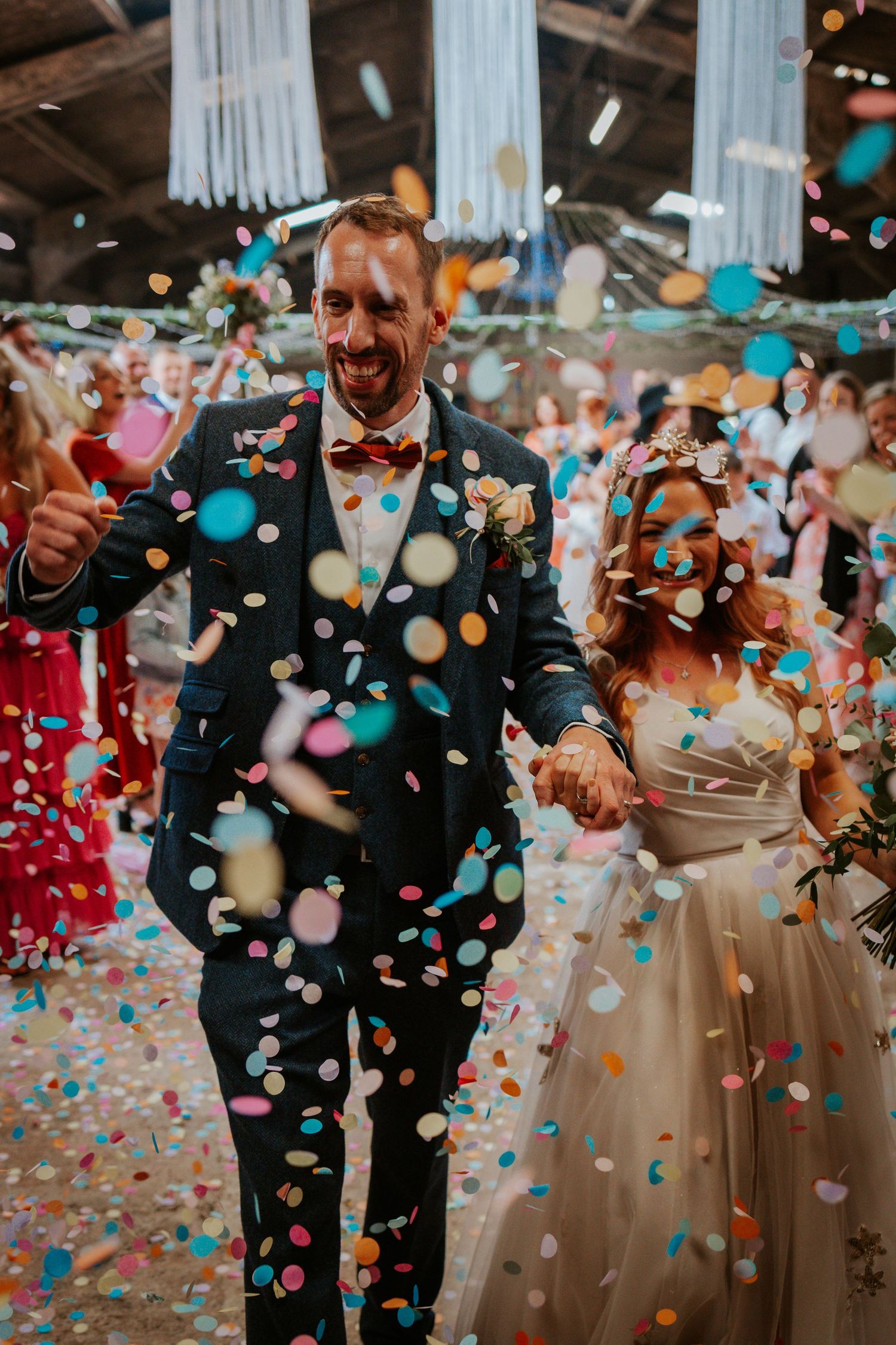 A celebratory moment with confetti raining down on a guest in a suit at a festive event.