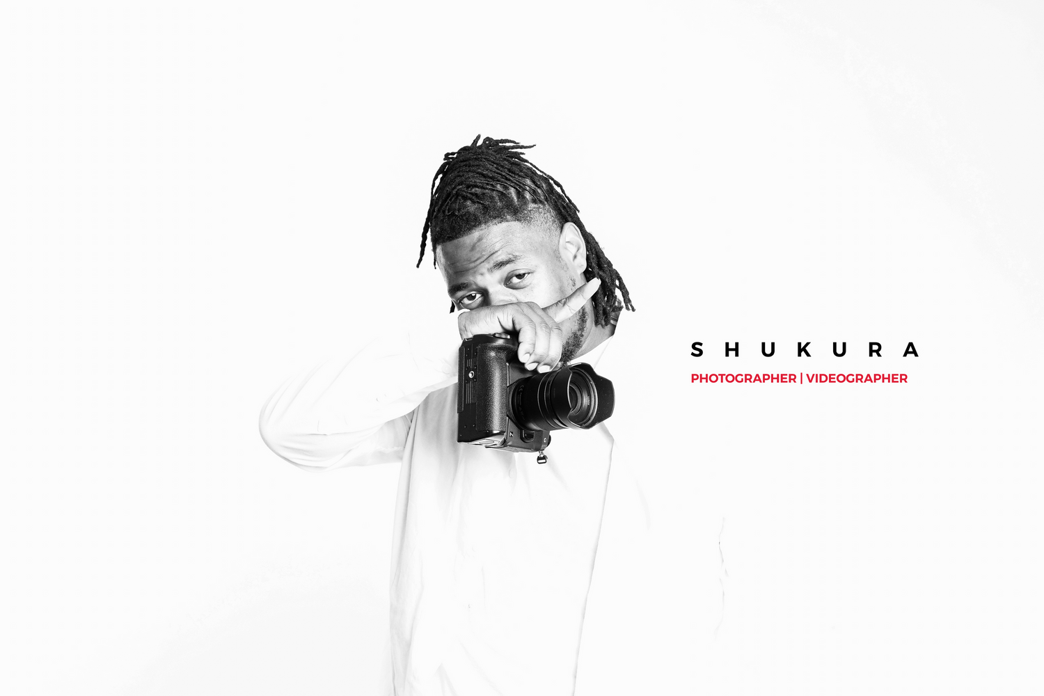 Minimalist black and white portrait of photographer holding camera.
