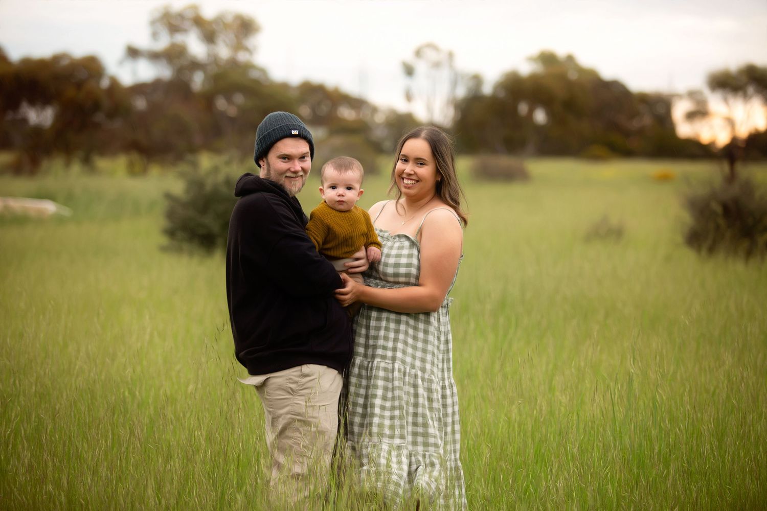 Kadina photographer, her husband and son in field cuddling and smiling