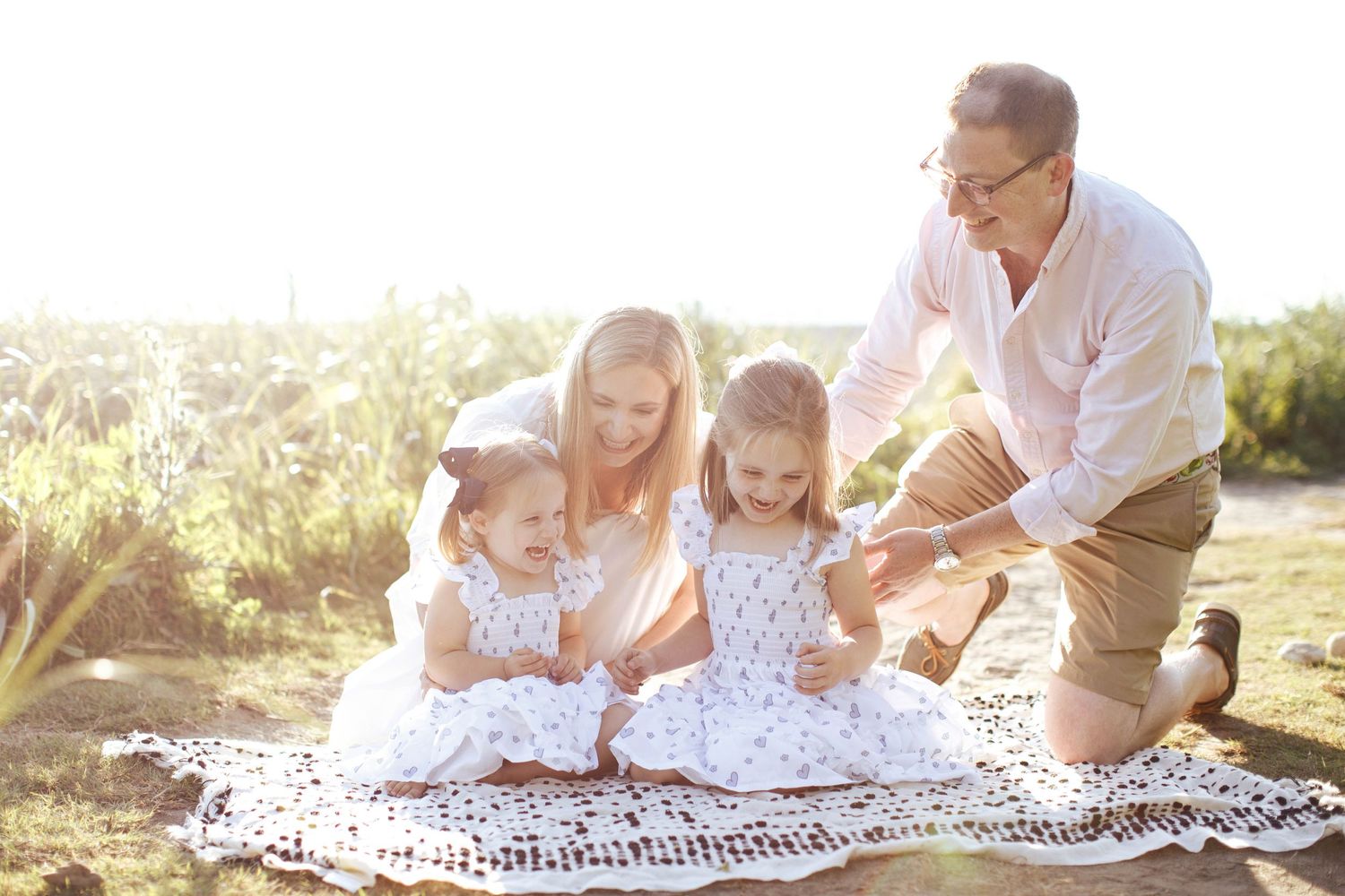 Everett Family Photography: A family of four play together at a photo session in Carkeek Park
