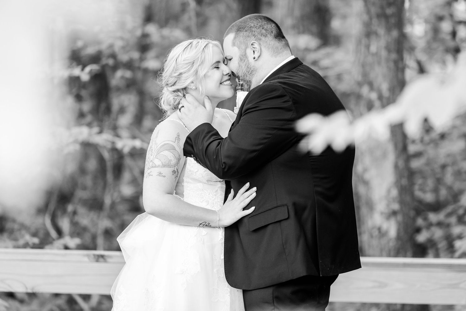 Intimate black and white portrait in a natural outdoor setting.