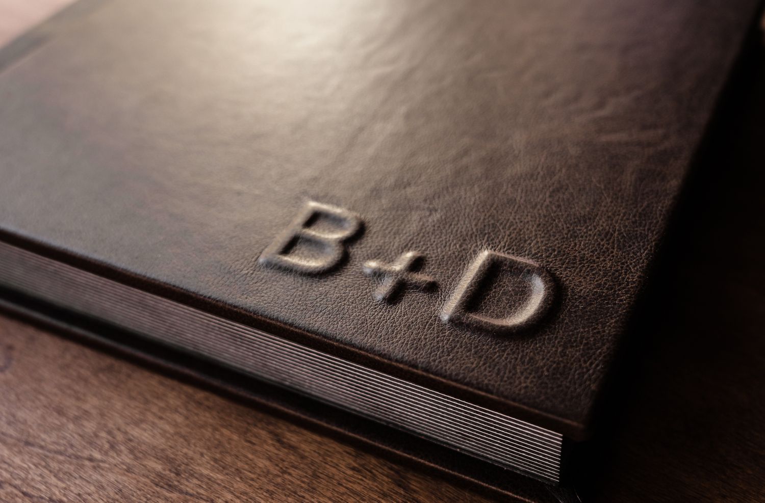Close-up of embossed leather texture on premium black photo album.