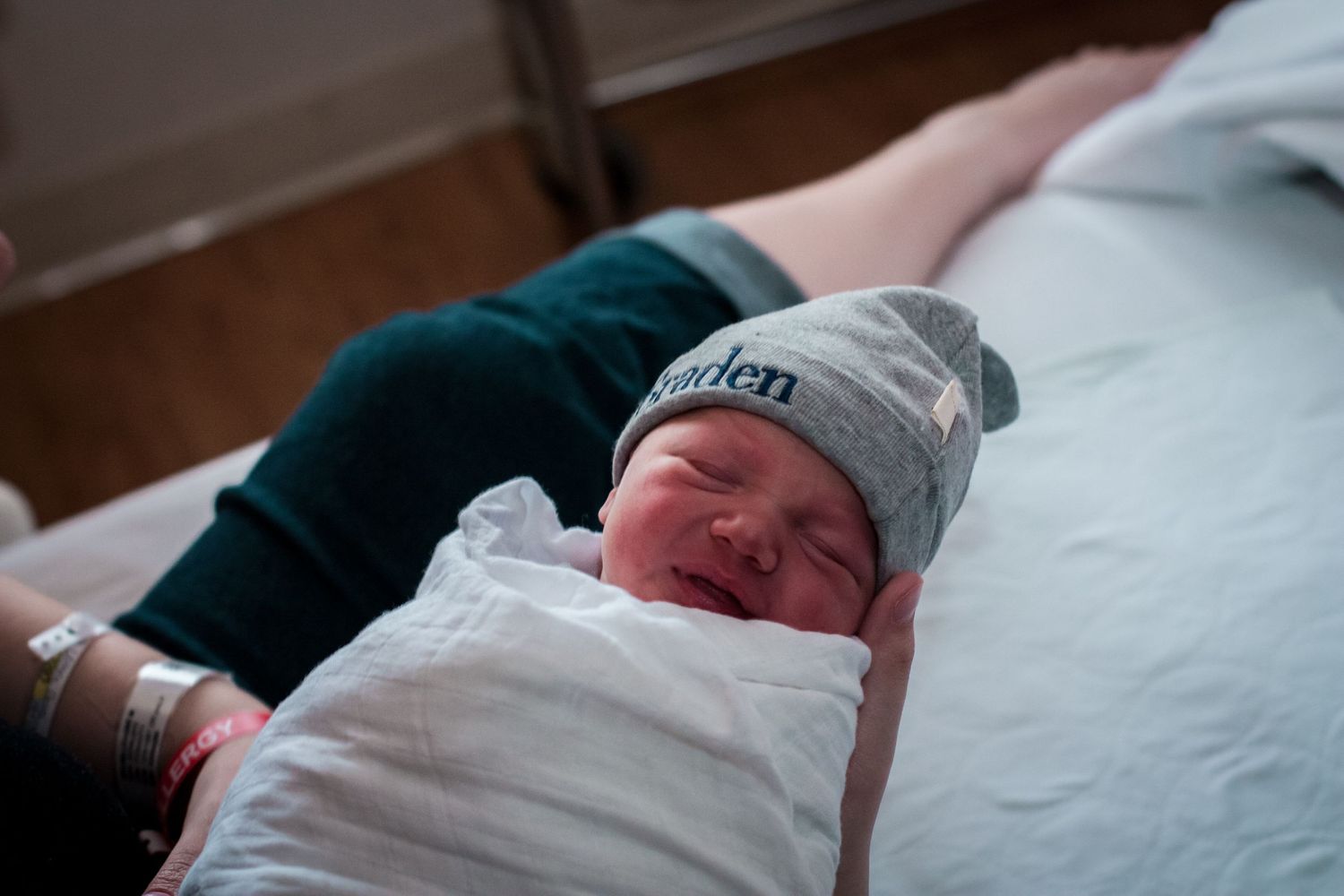 Newborn baby boy being held by his mother in the hospital during his fresh 48 session in Sioux City, IA.