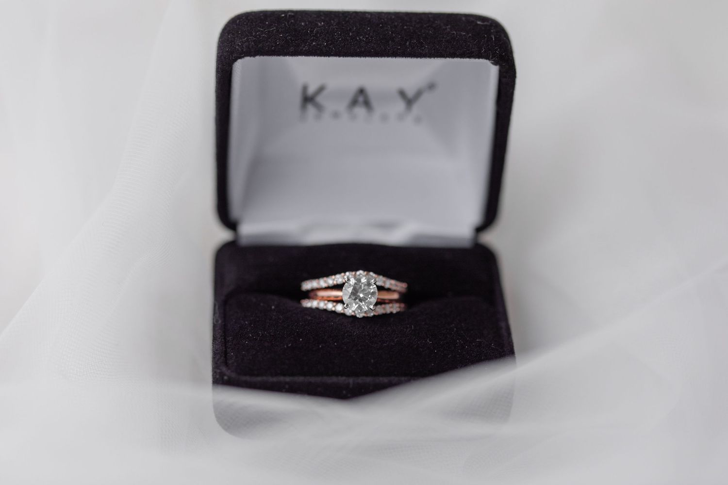 Close-up of Kay Jewelers engagement ring box on white background.