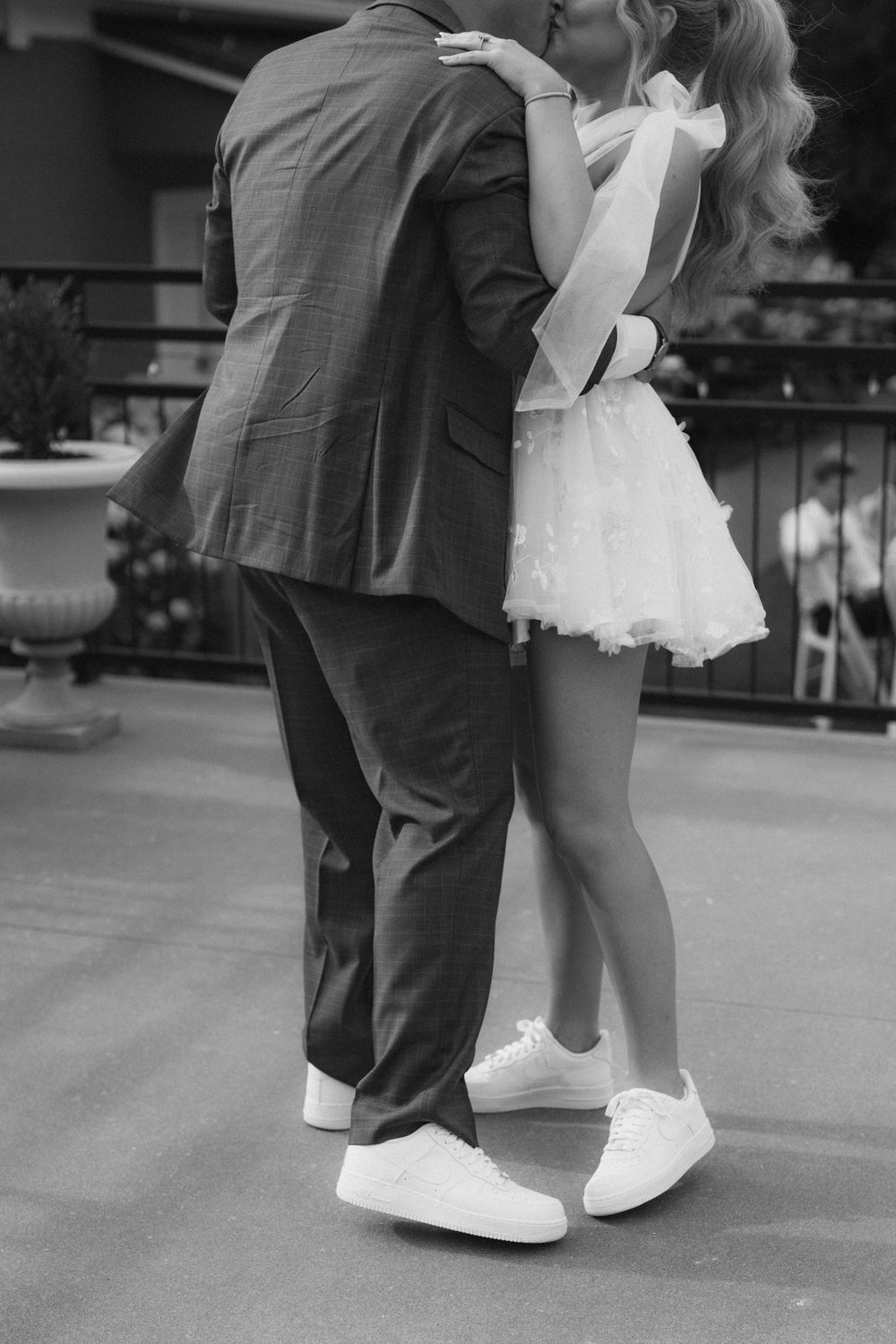 Close-up shot of dancing feet, with a white dress and formal suit visible.