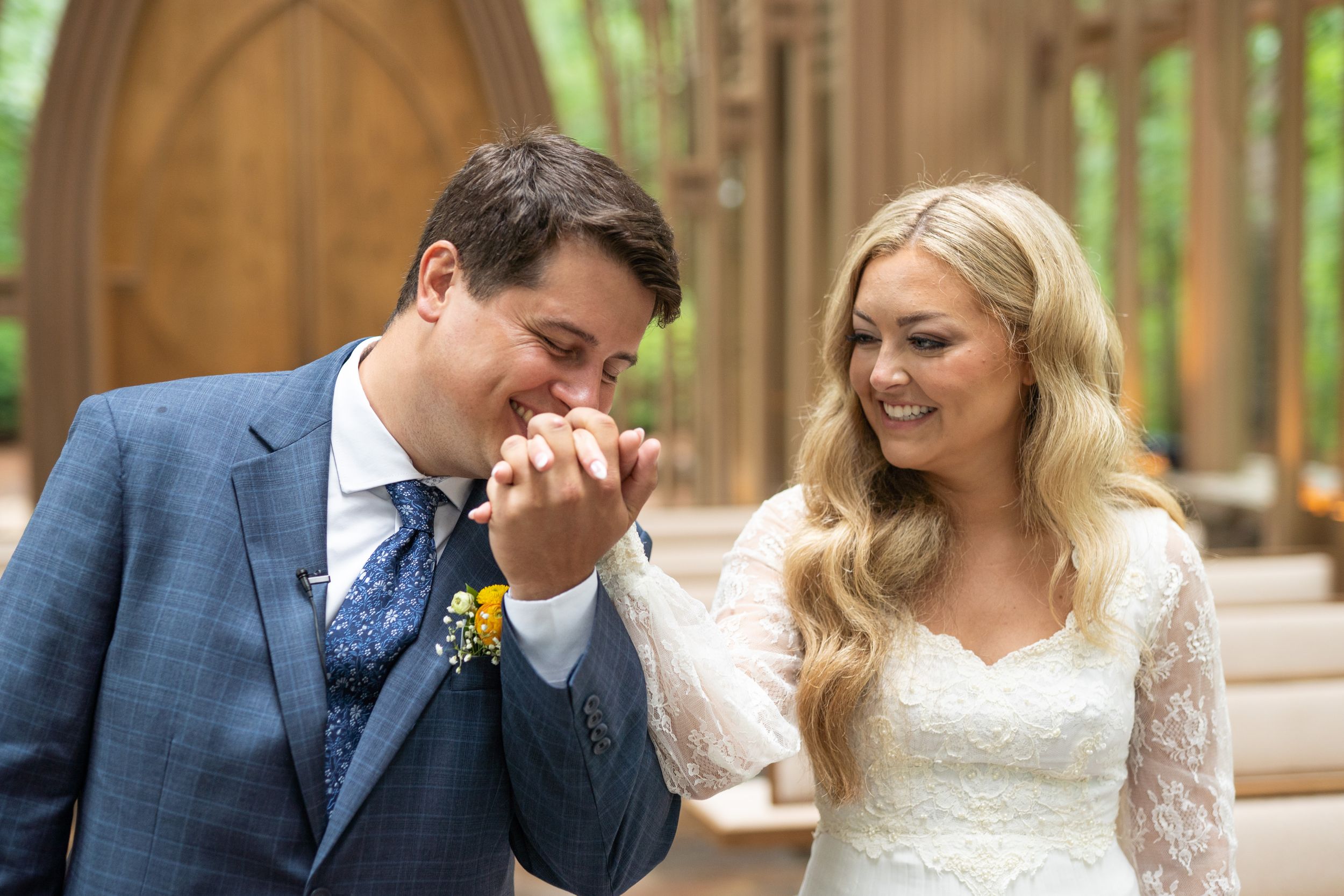 Romantic moment captured in garden chapel with wooden gothic arches.