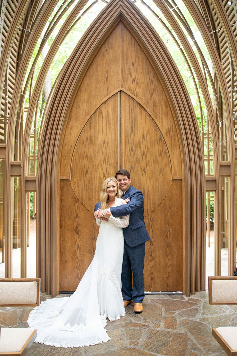 Wedding ceremony in a wooden chapel with elegant arched beams and natural lighting.