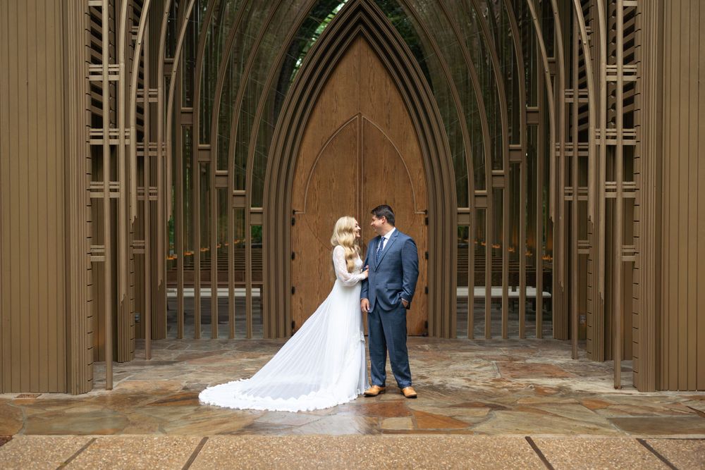 Wedding ceremony location with gothic wooden arches in a chapel-like setting.