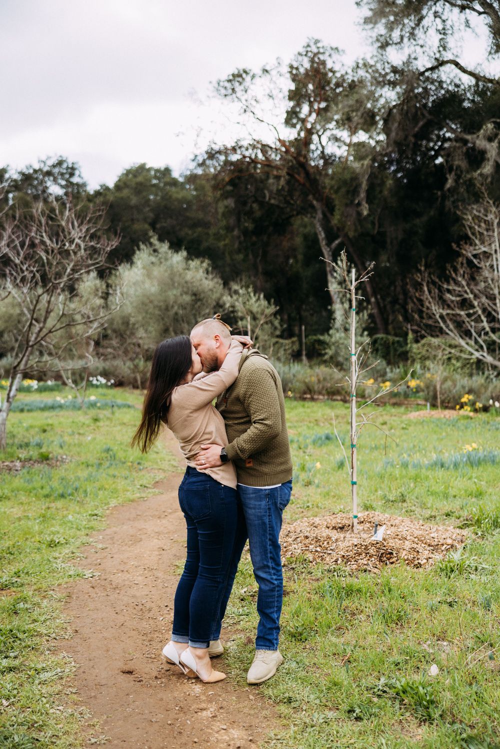 Couple kisses in meadow at Filoli in Woodside, CA