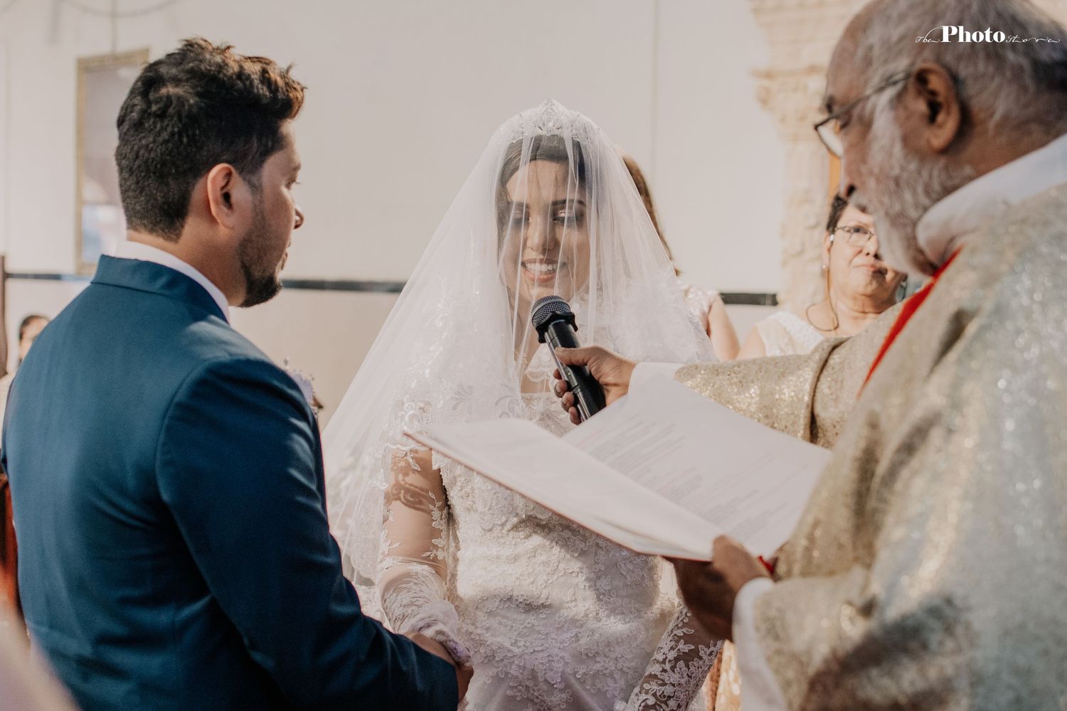 Wedding ceremony proceedings with white lace details in a church setting.